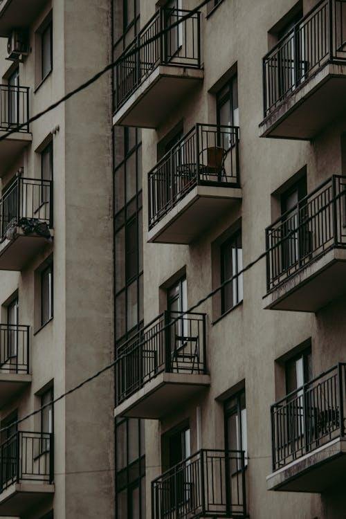 An image of an apartment building with metal railing balconies